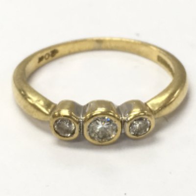 An 18ct gold three stone diamond ring , 2.3g. Size J Postage category A