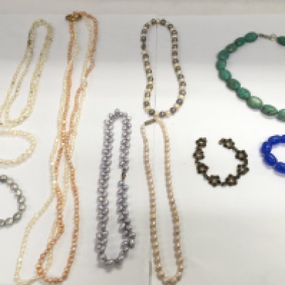 A collection of freshwater pearl necklaces and bracelets. Also including a silver bracelet and turquoise stone necklace with a blue stone possibly jade bracelet.