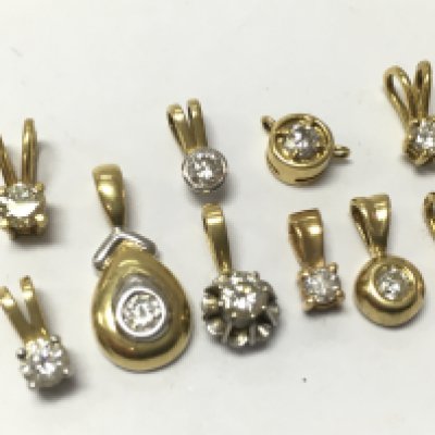 A collection of 18ct yellow and white gold pendants set with diamonds , 7.45g . Postage category A