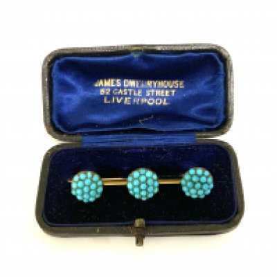 A small Edwardian unmarked gold brooch inset with turquoise beads. (A)