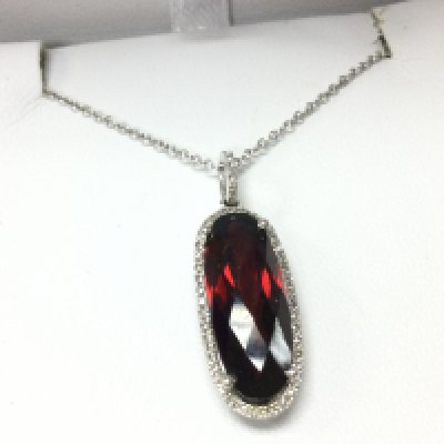 A 9ct white gold garnet and diamond necklace , 3.2g total weight. With receipts . Postage category A