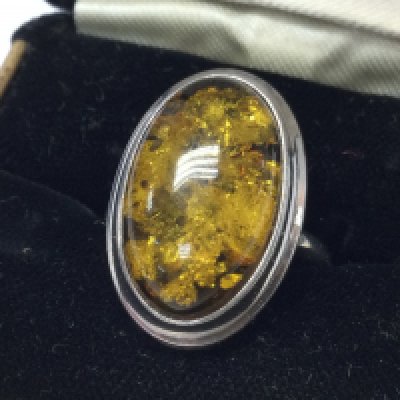 An amber silver ring, size Q. postage category A