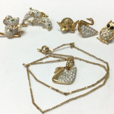 Swarovski brooches and a necklace with swan pendant