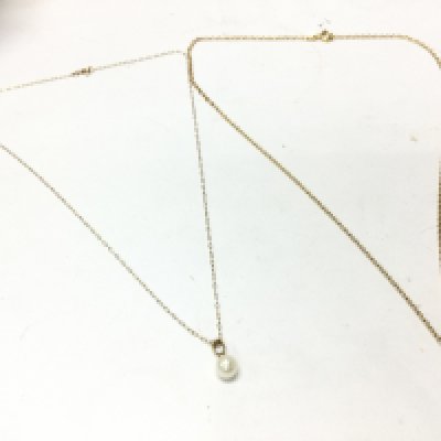 9 carat gold necklaces, one with initial pendant and the other a cultured pearl . 2.7g total weight. Postage category A