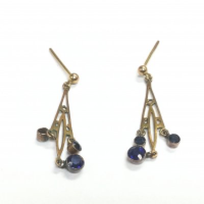 A pair of unmarked gold earrings set with small blue sapphires, approx 1.5g. Shipping category A.