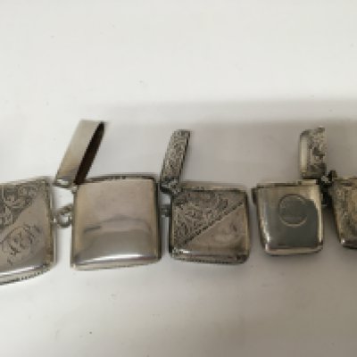 Five silver Vesta cases some with engraved floral pattern all with clear assay marks.