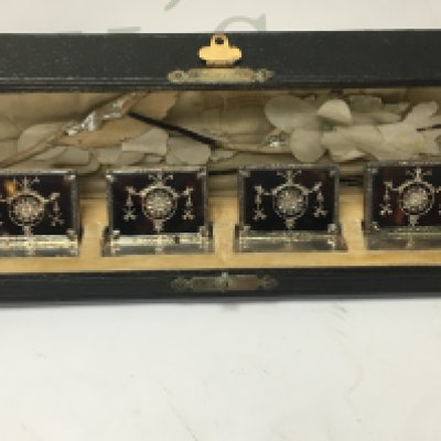A cased set of four silver and tortoiseshell menu holders