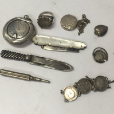 A small collection of silver items including jewellery fruit knife bracelet and pendants.