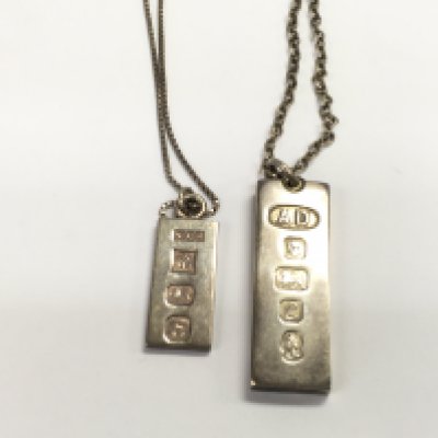 Two silver ingots on chains. 48.72g Postage A