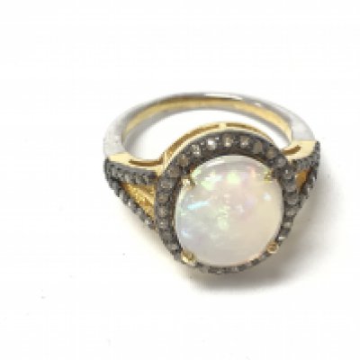 A diamond and Opal oval cluster ring. Opal approx 1.9ct and diamond 0.38 total. Ring size N. Postage A