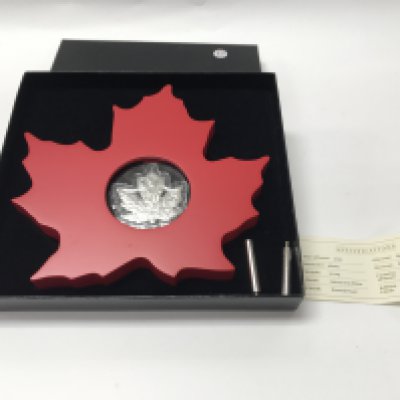A silver 1oz proof cut out maple with display stand and COA. Postage B