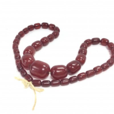 A red amber/ bakerlite bead necklace , 32cm long. Postage category A