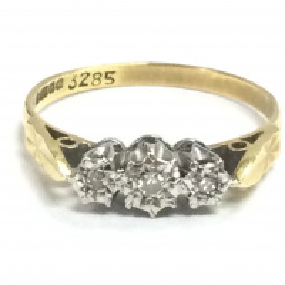 An 18ct gold ring set with three chip stone diamonds. Size O. 2.3g. Postage category a