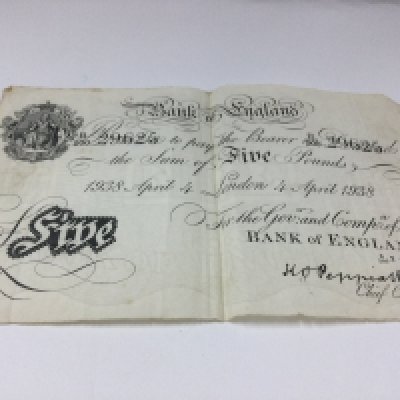 a collection of bank notes including a 1938 white five pound note.