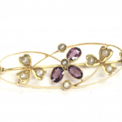 A 9ct gold edwardian seed pearl and amethyst brooch, 2g. Postage category a