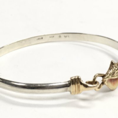A 14 carat gold and silver bangle , 9.4g. Postage category a