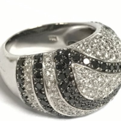 A ladies 18ct white gold ring set with a pattern of diamonds including black diamonds, size N, 11.9g. Postage category A