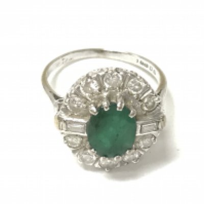 An 18ct white gold emerald and diamond ring. 5.30g and size N.