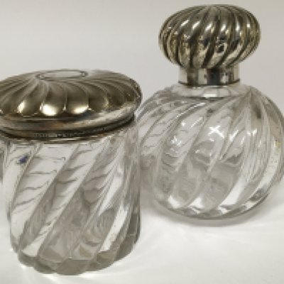 A Victorian silver topped and glass scent bottle and a silver topped tidy jar. Hight 15cm . (2)