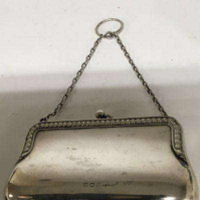 A ladies Silver purse with a fitted leather interior.11cm x 15cm