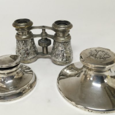 A pair of silver mounted opera glasses and two silver capstan type silver inkwells.