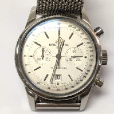 Men's Breitling Transocean Chronograph stainless steel 38mm silver dial. No box or papers. Seen running. Breitling steel mesh bracelet with fold over clasp. Over all in very good condition.