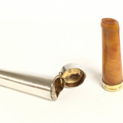 A 9ct gold and amber cheroot holder and a silver. Postage category A