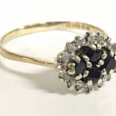 A 9 carat gold sapphire and diamond set cluster ring. 2.1g. Size Q. Postage category a