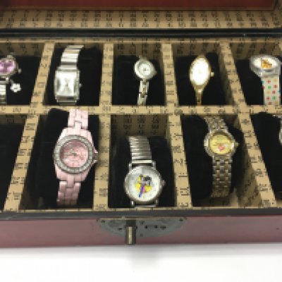 A collection of dress watches in a watch box. Postage B