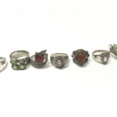 7 silver rings set with asssorted stones. 49.29g total. Postage A