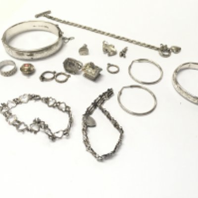 A collection of assorted silver jewellery including bracelets charms etc. 92.56g Postage B