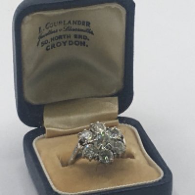 A Quality diamond cluster and platinum ring set with six round old cut diamonds in a floral pattern the shank set with smaller diamonds. each diamond approximately 0.25 -0.35 of a carat total carat weight approximately 1.5carat colour grade I/J clarity SI2. Total weight 4.5g ring size M. Sold with independent Gemologists Report.