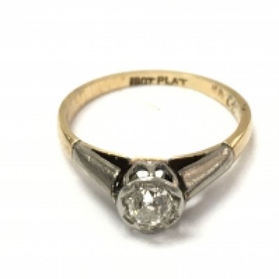 An old cut solitaire diamond set in platinum and 18ct gold ring. Size L 1/2 and 2.55g. Approx 0.30 diamond.