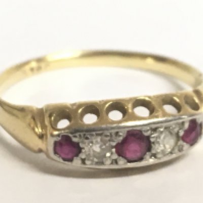 A 9 carat gold ruby and diamond set ring. Size N Postage category A