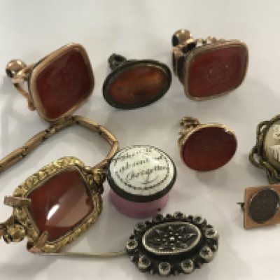 A collection of Georgian and later watch fob seals, together with two brooches and an enamel pill box
