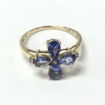 A 9ct yellow gold ring set with 4 pear shaped tanzanite and small diamonds. Tanzanite 0.80ct and 0.02ct diamonds approximately. Size Q and 2g. Postage A