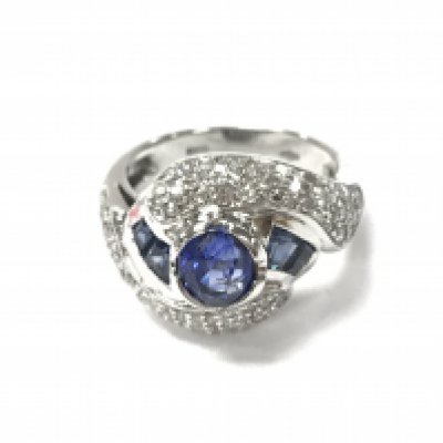 A platinum ring set with sapphires and brilliant cut diamonds. Circa 1950s. Size J and 6.90g.Postage A
