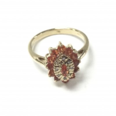 A 9ct yellow gold ring set with round orange sapphires and diamonds. Sapphires 0.50ct and diamonds 0.08ct approximately. 3.5g and size N