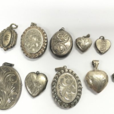 A collection of silver lockets. Postage category A
