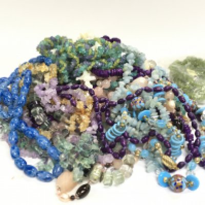 A collection of gemstone necklaces , postage category C