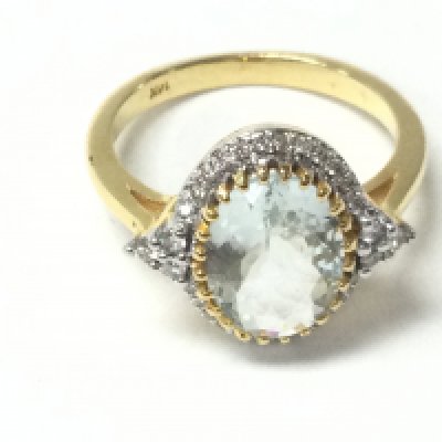 A 14ct yellow gold oval aquamarine and R/C diamonds set cluster ring with diamond shoulders. Aquamarine 2.01ct and diamonds 0.23ct approximately. Size O. Postage A