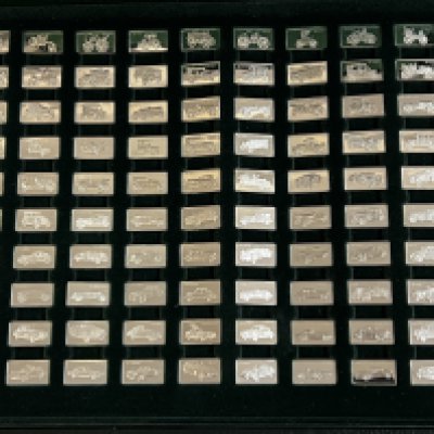 A cased set of John Pinches Ltd silver ingots, 'The 100 Greatest Cars' silver miniature collection in presentation case with booklet.