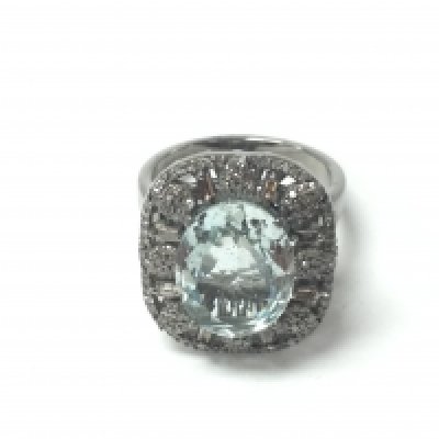 An ornate silver dress ring set with a central oval aquamarine within a surround of baguette cut and RBC diamonds set to an open work mount. Aquamarine 4.80ct and diamonds 0.65ct approx. Size P 1/2. Postage B
