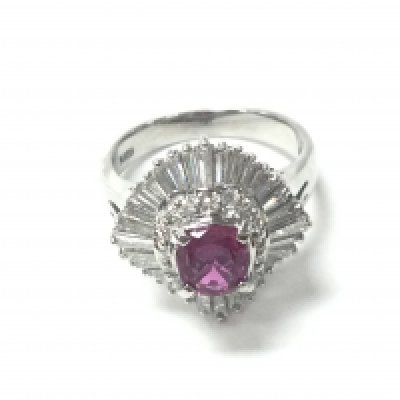 A platinum ruby and diamond ballerina-style ring. Ruby 0.76ct and tapered baguette diamond 1.01ct approx. Size L and 9.2g. Postage B