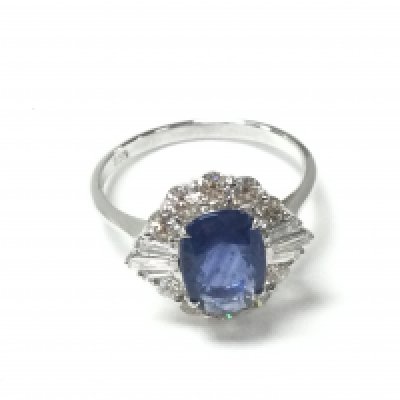 An 18ct white gold ring set with oval-cut sapphire surrounded by RBC cut and baguette cut diamonds with certificate. Size O. Sapphire 2.06ct and diamond 0.85ct. Postage B