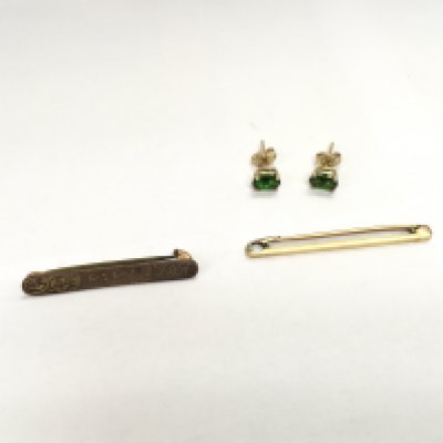 A 14ct bar brooch, a 9ct bar brooch and a pair of 9ct gold green stone studs. Approx weight 3.65 grams.