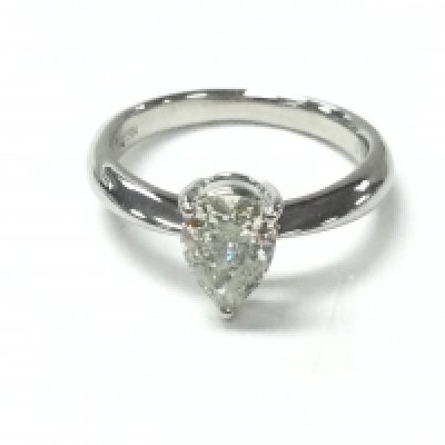 A platinum solitaire ring set with a 1.04ct pear shaped diamond with certificate. Ring size M 1/2. Postage A