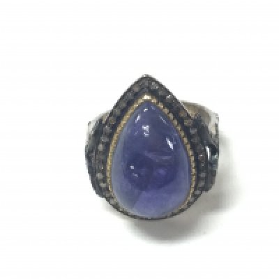 A pear shaped cabochon tanzanite and diamond framed ring in gold plated silver. Tanzanite 10.18ct rose cut diamonds 0.39ct approx. Size M 1/2 Postage A