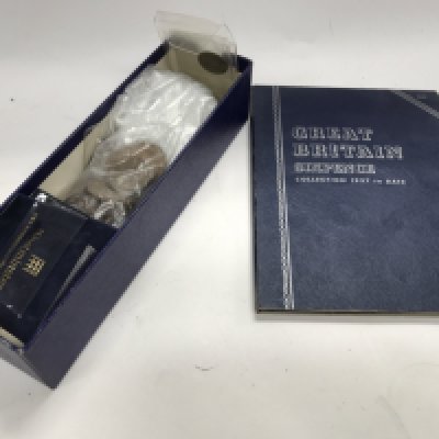 A collection of used world coinage in a box and album.