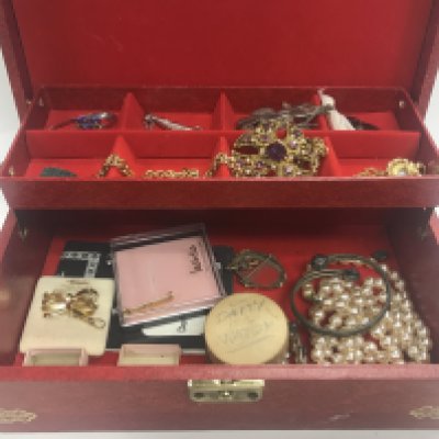 A box of costume jewellery including some silver items and watch parts.